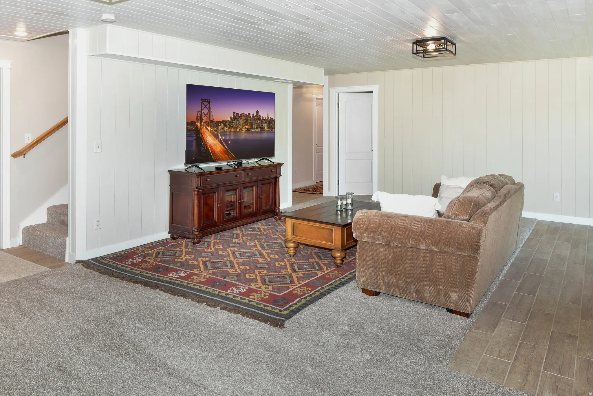 Living area featuring wood tiled floors and stairway