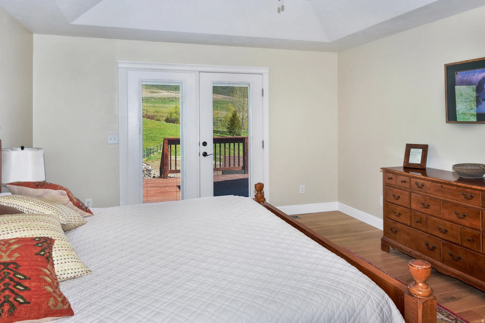 Bedroom featuring dark wood finished floors, access to exterior, french doors, and vaulted ceiling