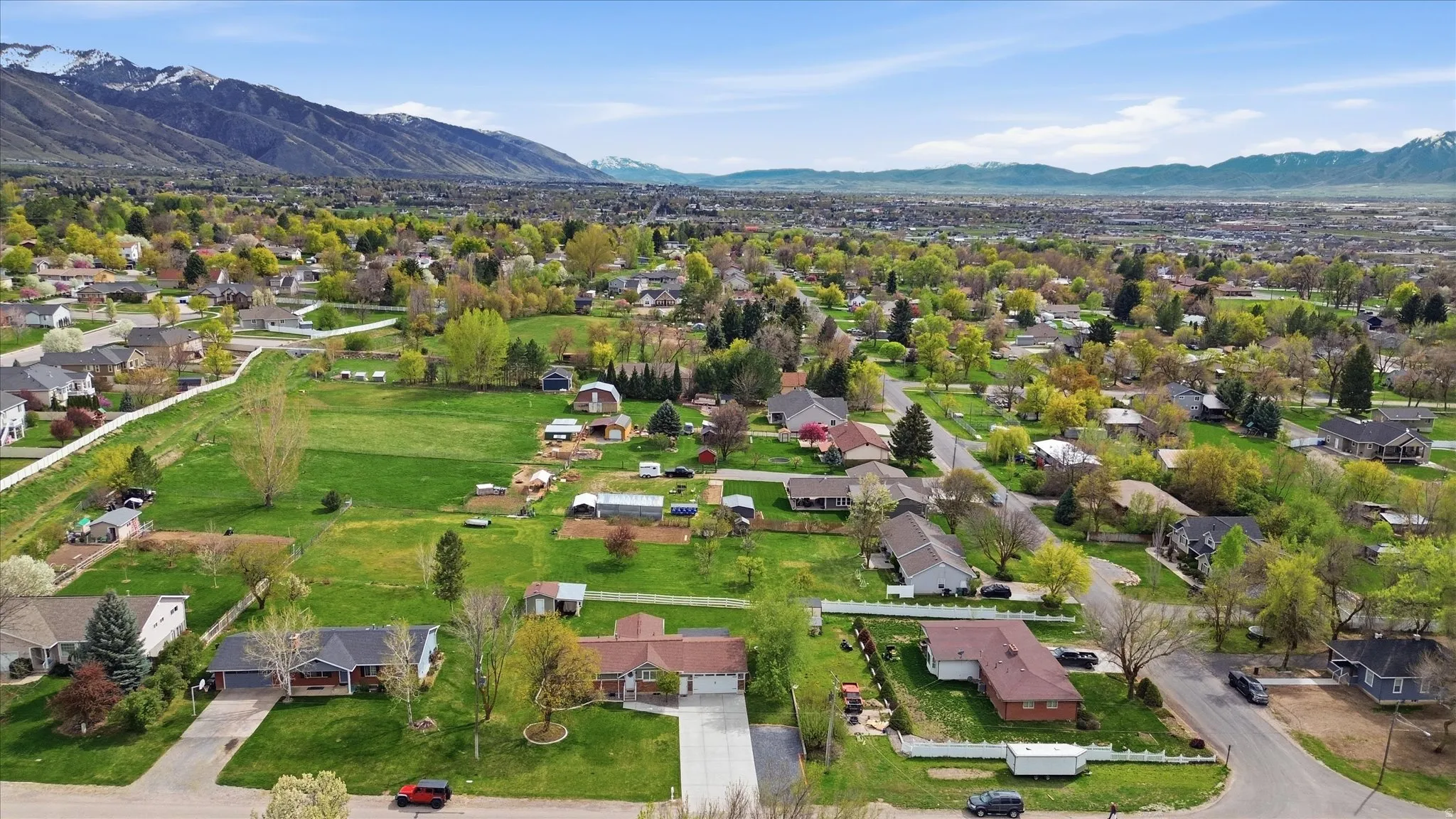 Aerial perspective of suburban area featuring a mountain backdrop