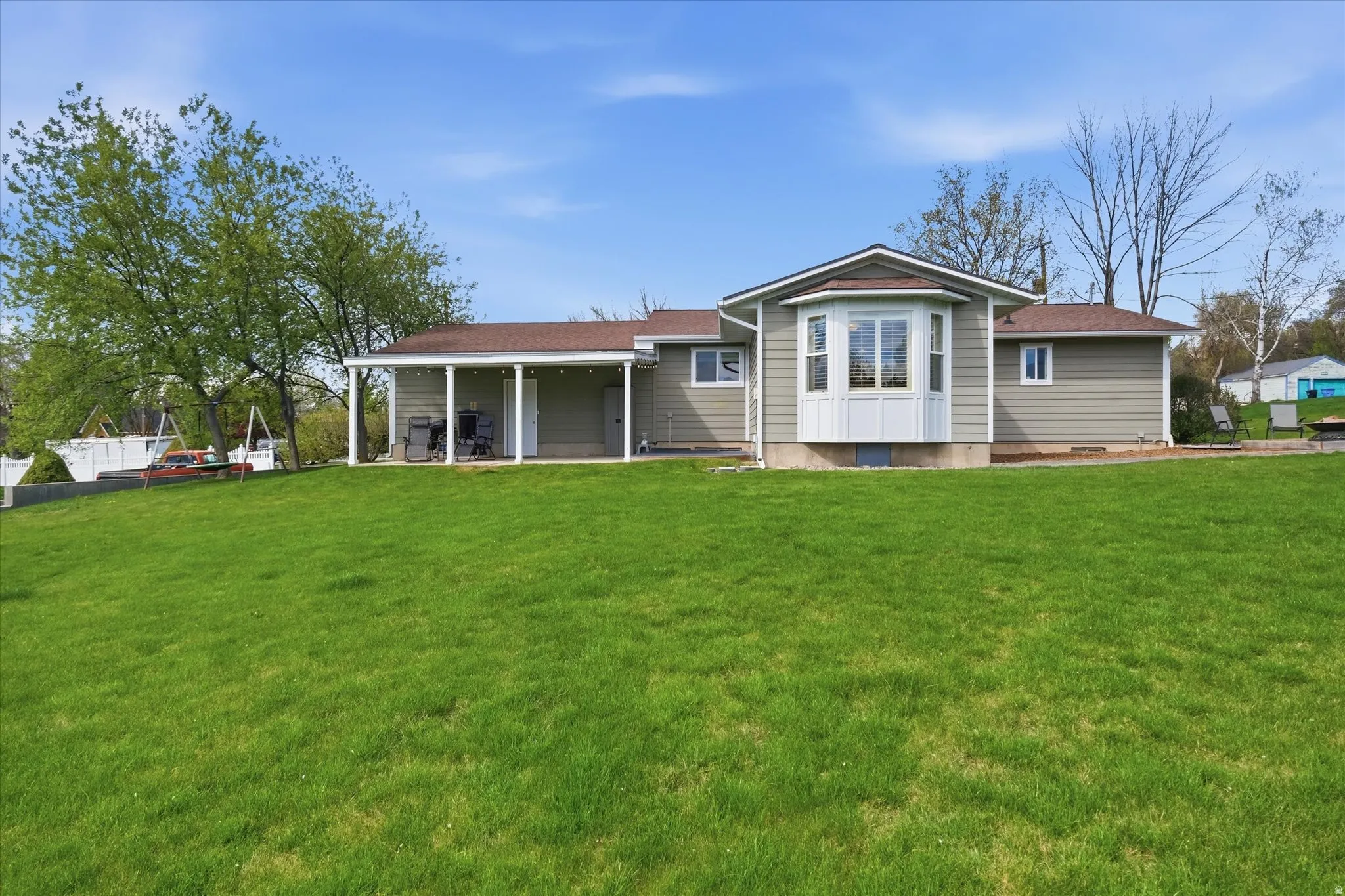 Rear view of house featuring a yard, crawl space, and a patio area