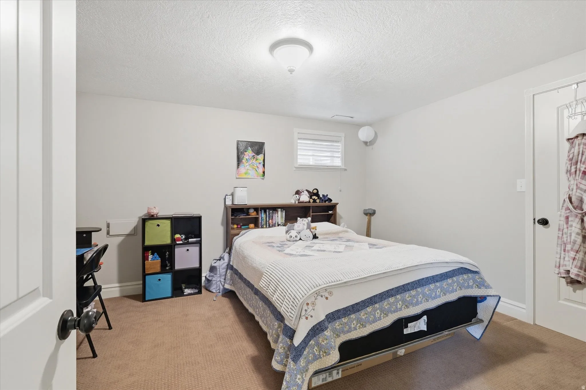 Bedroom featuring carpet floors and a textured ceiling