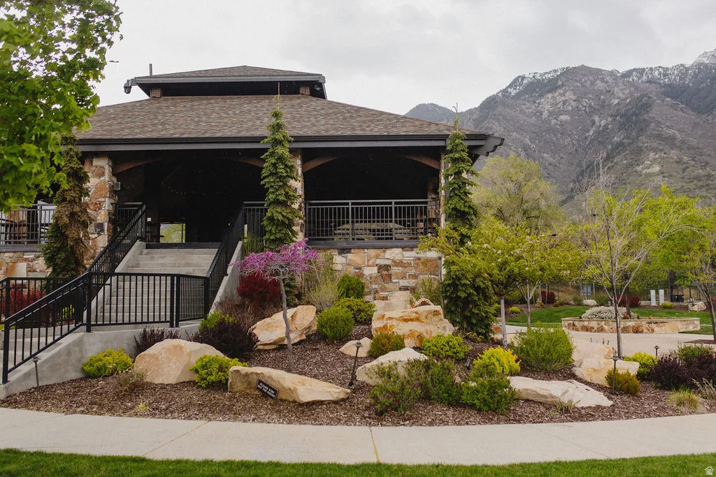 View of front of property with a shingled roof and a mountain view