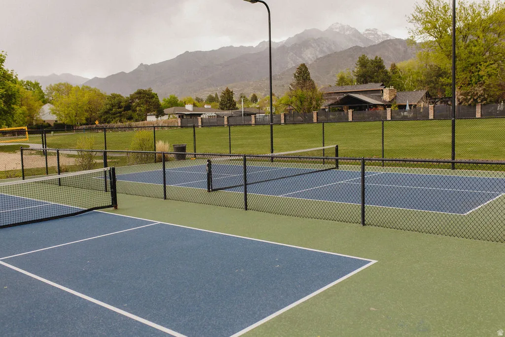 View of tennis court with a mountain view