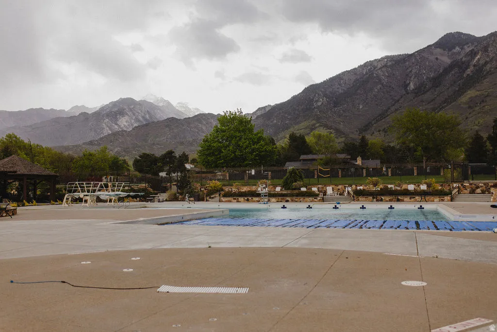 Community pool featuring a mountain view and a patio