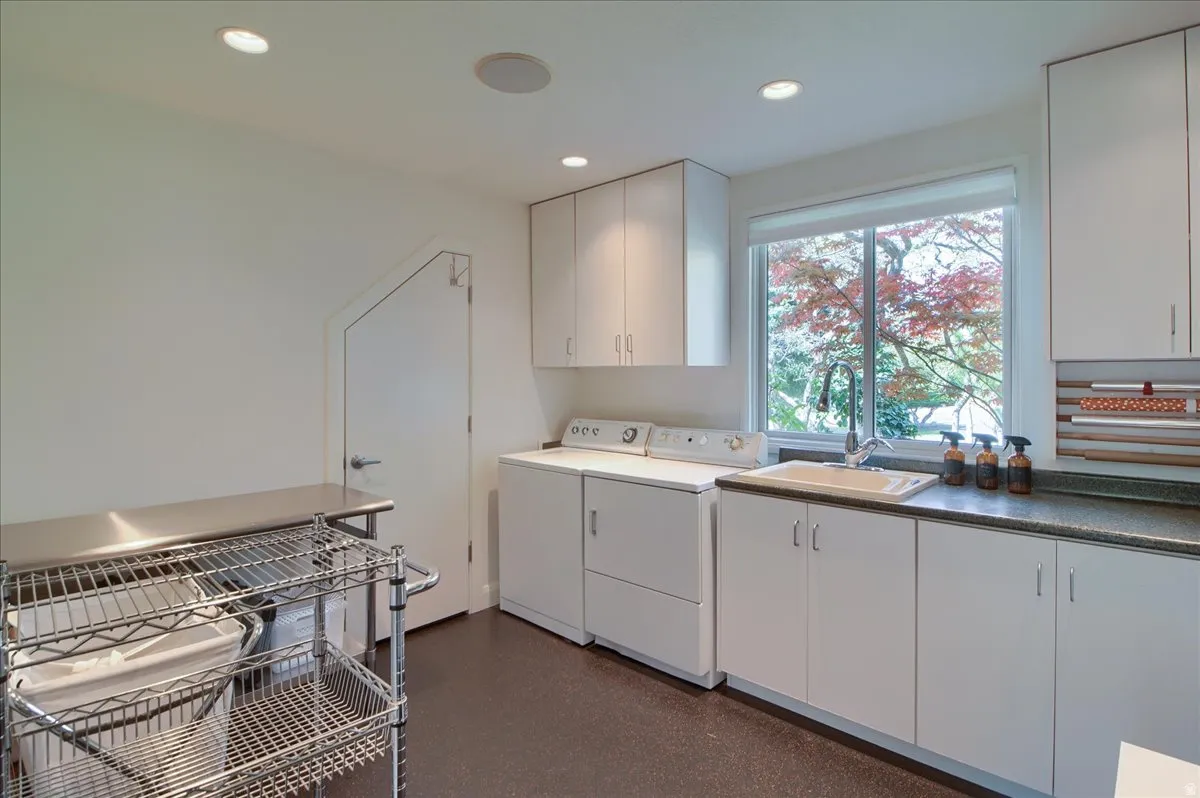 Laundry area with cabinet space, washer/dryer, and recessed lighting