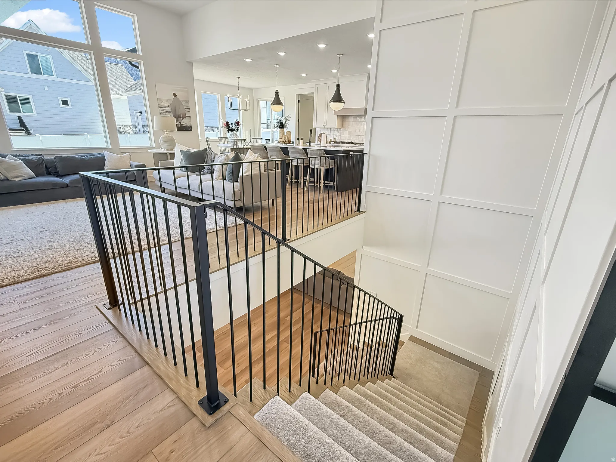 Stairway with recessed lighting and wood finished floors