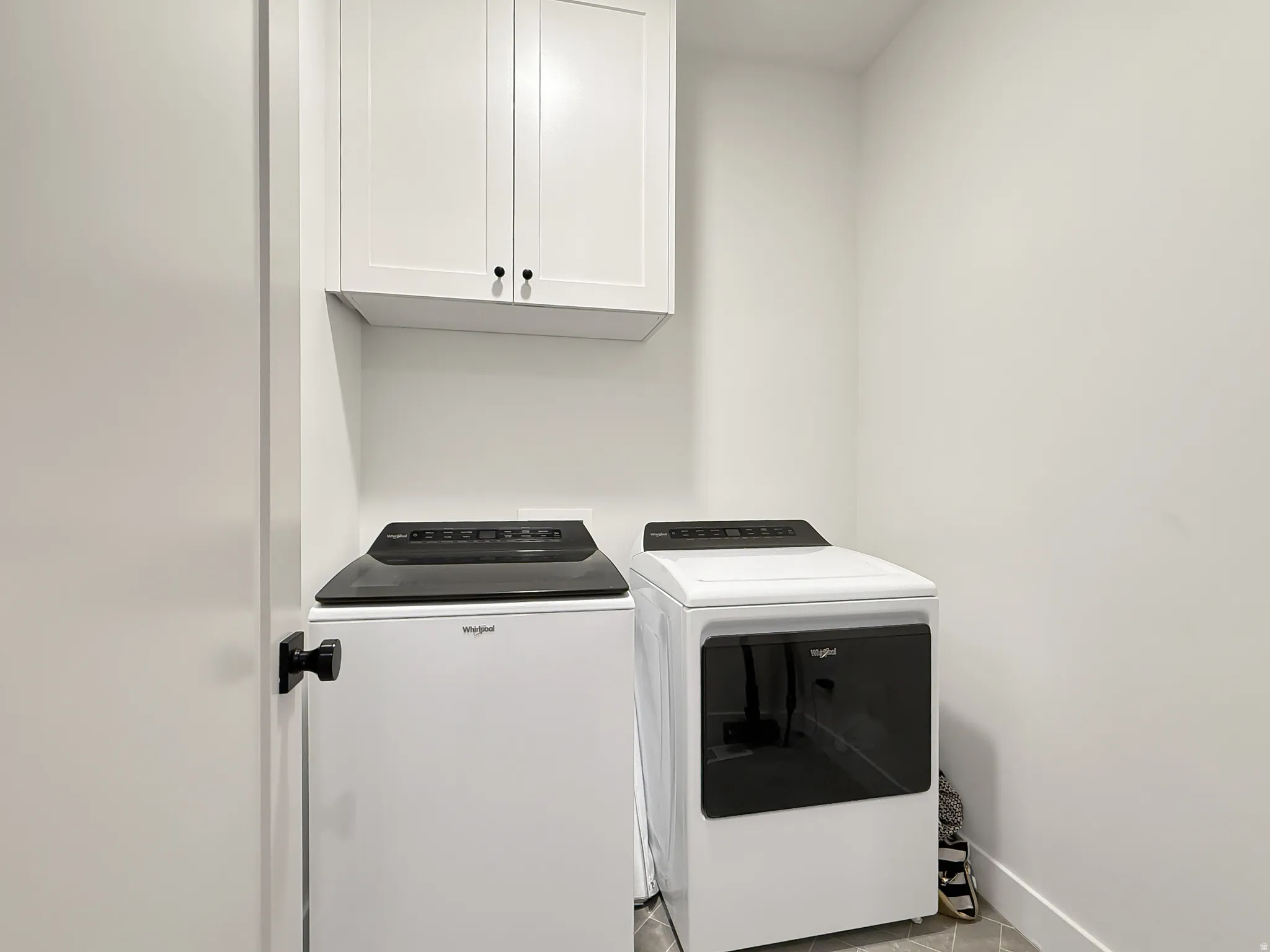Laundry room with cabinet space and washer and clothes dryer