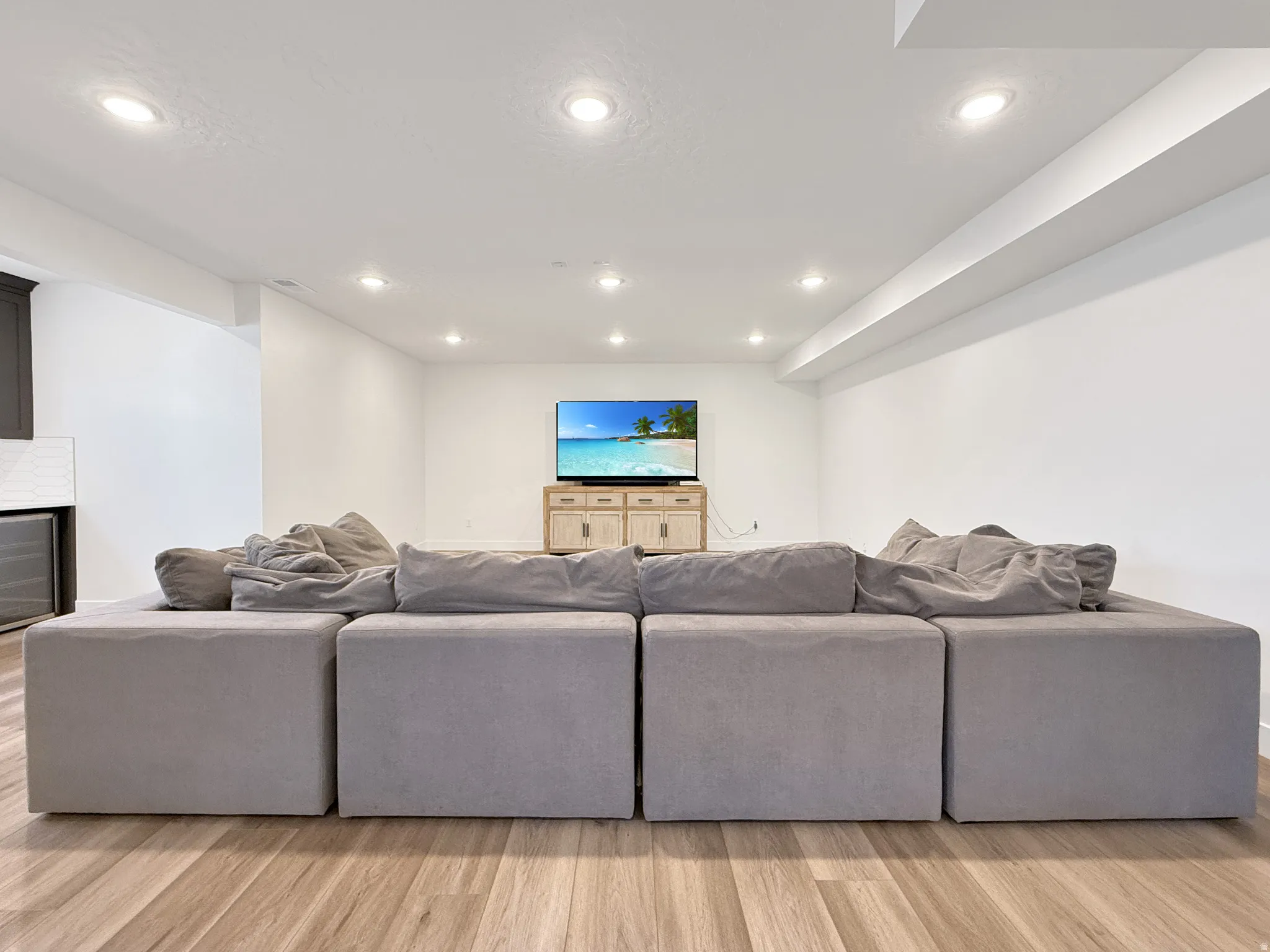 Living area featuring light wood-style flooring and recessed lighting