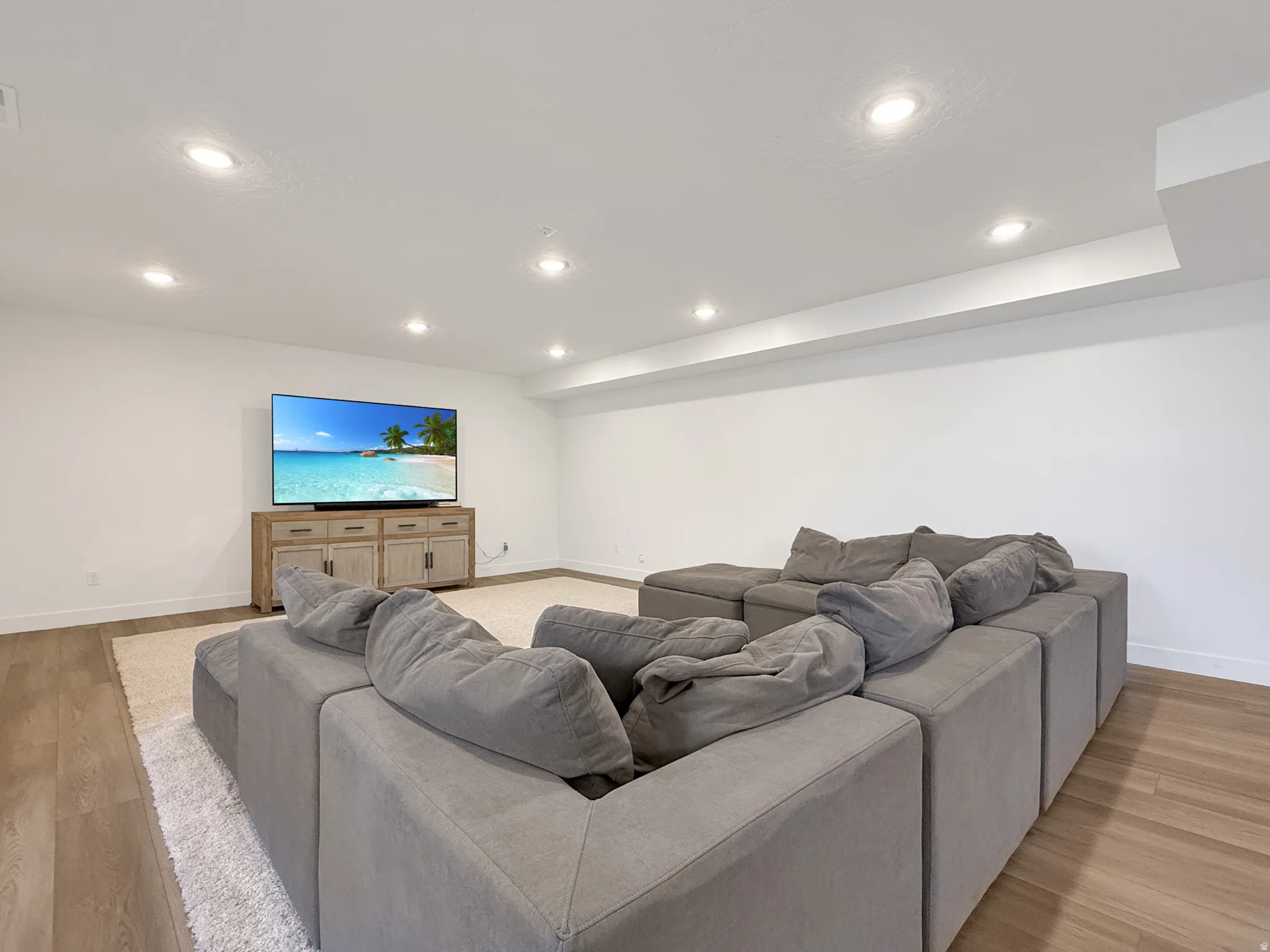 Living room featuring light wood finished floors and recessed lighting