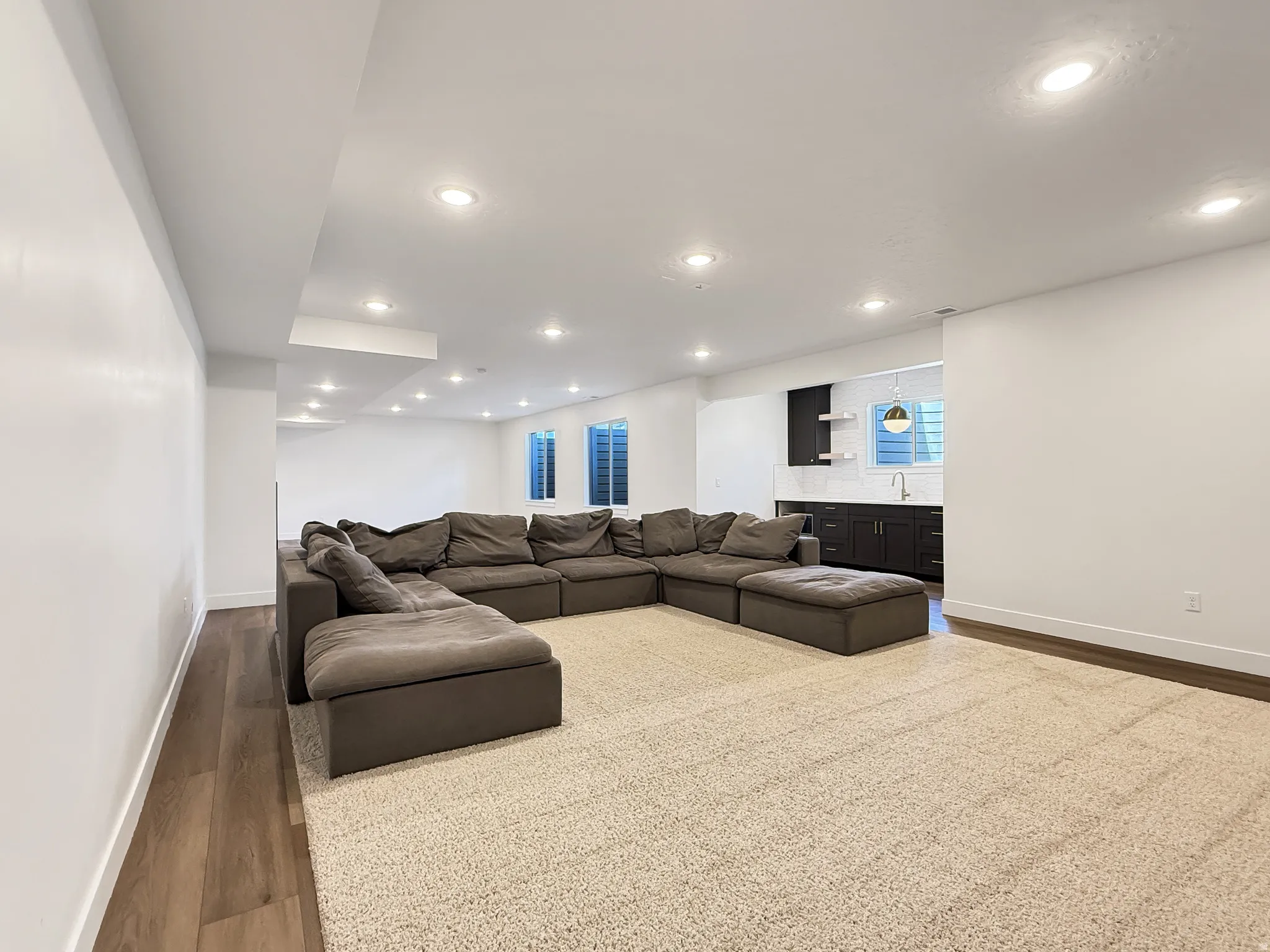 Living area featuring wood finished floors and recessed lighting