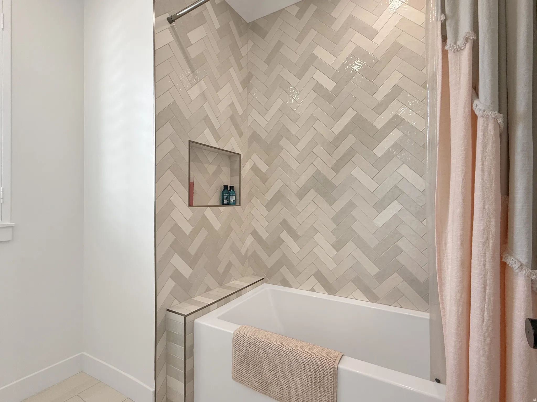 Bathroom with shower / bathtub combination with curtain and light tile patterned floors