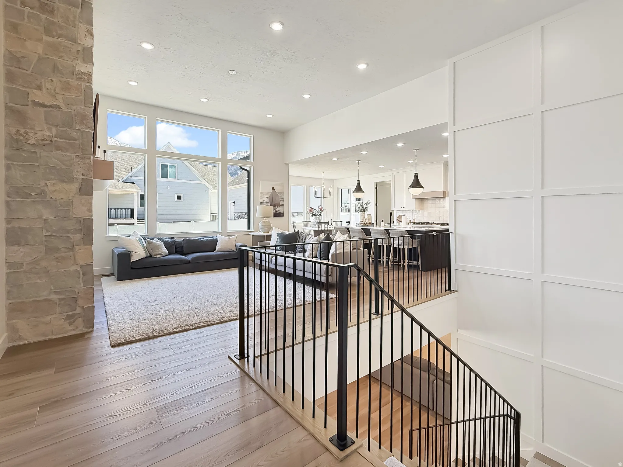 Living area with light wood-style floors and recessed lighting