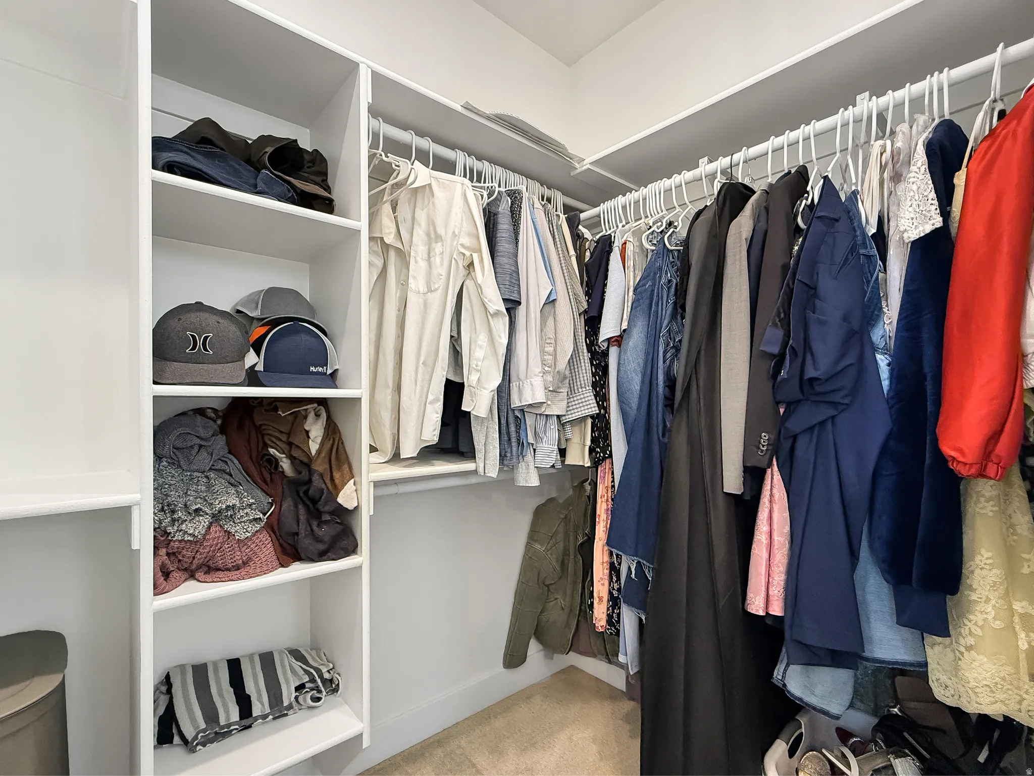 Walk in closet with light carpet