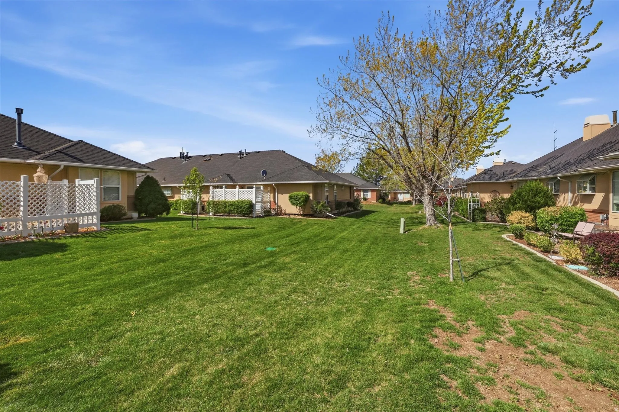 View of green lawn with a residential view