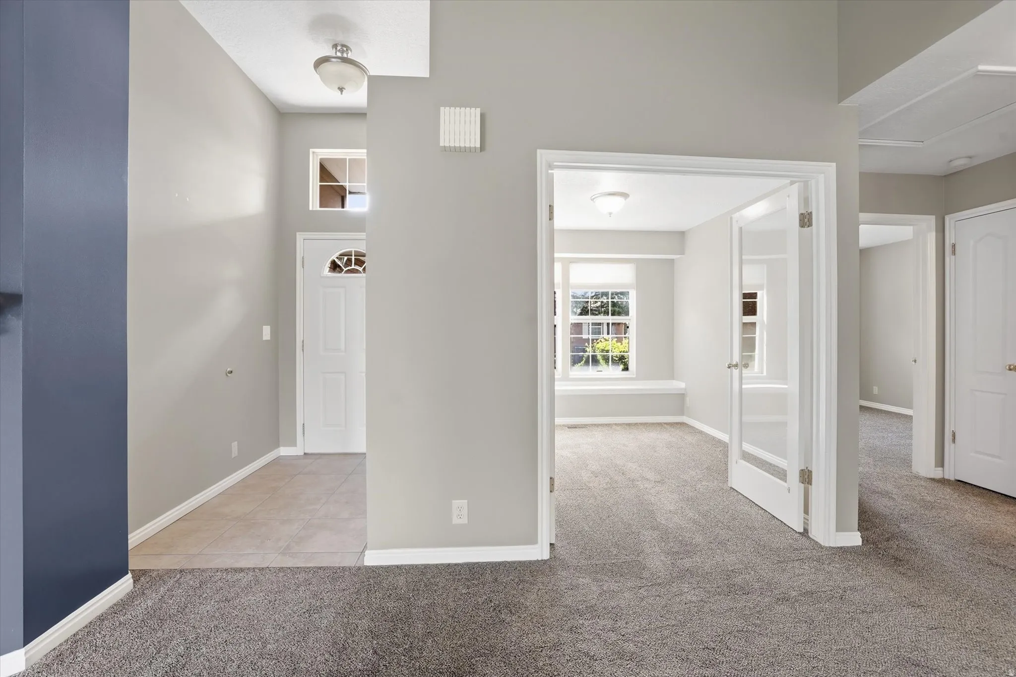 Front entry doorway and view of front office with French doors