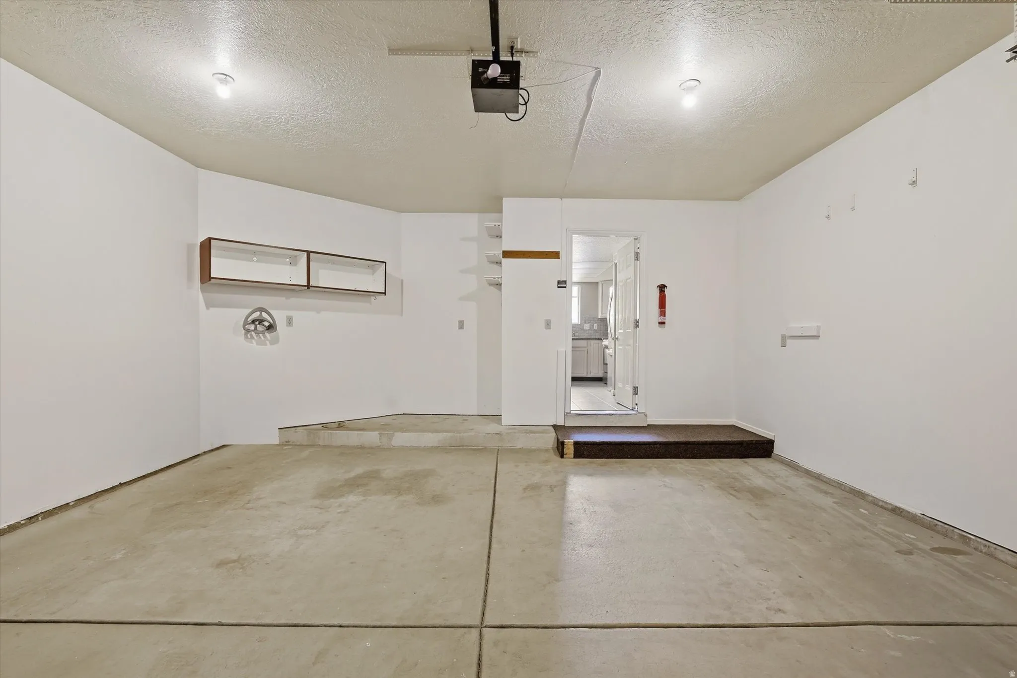 Garage featuring a garage door opener