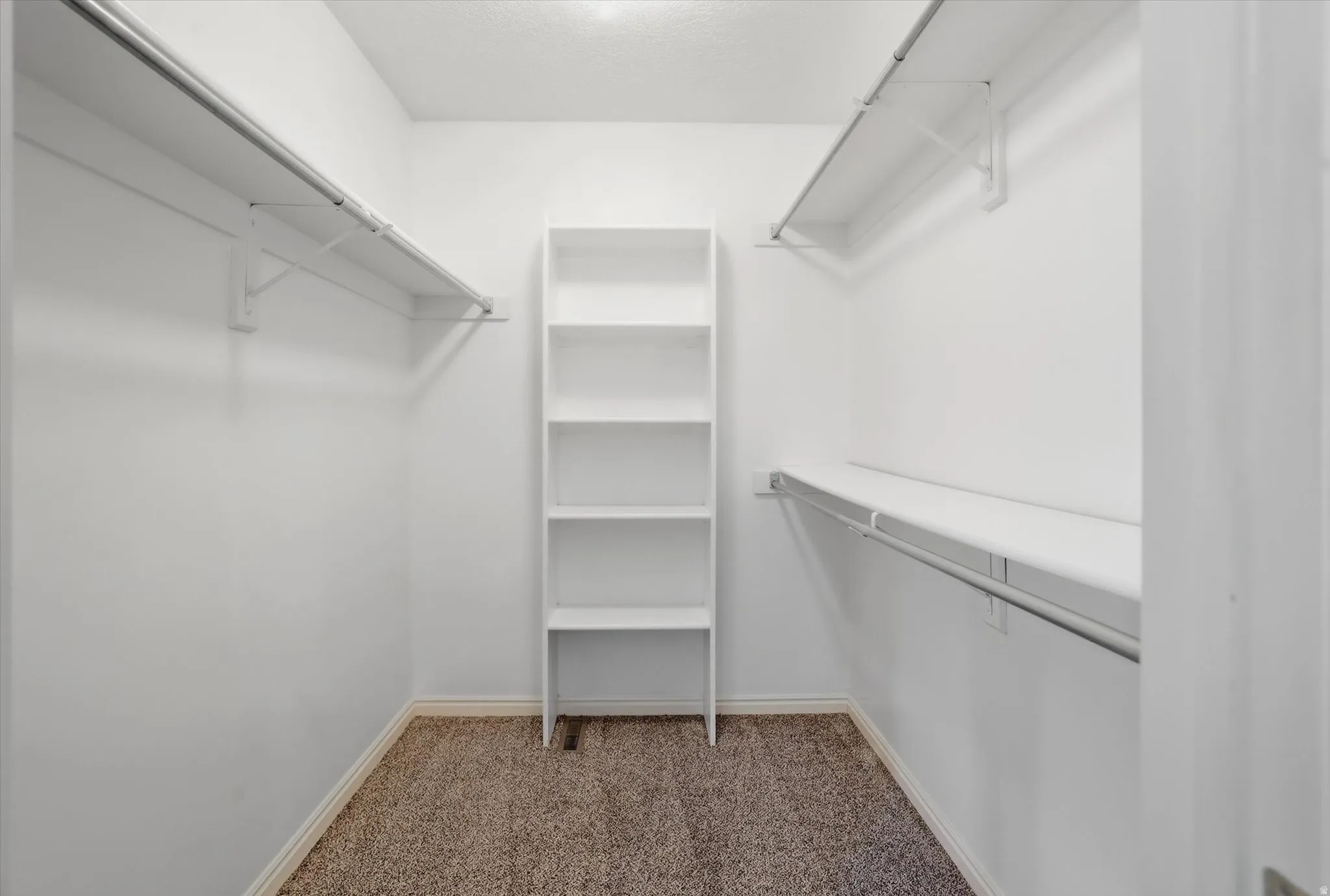 Walk in closet with shelves and clothing space