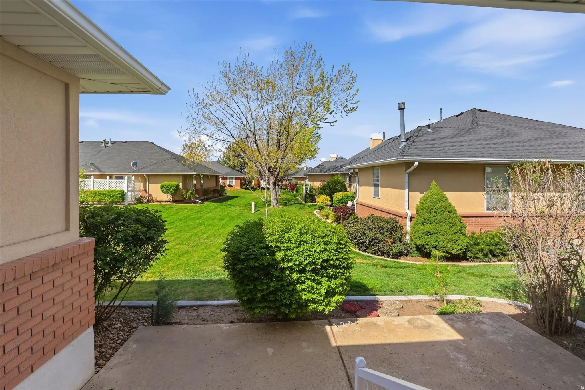 View of green lawn with a residential view