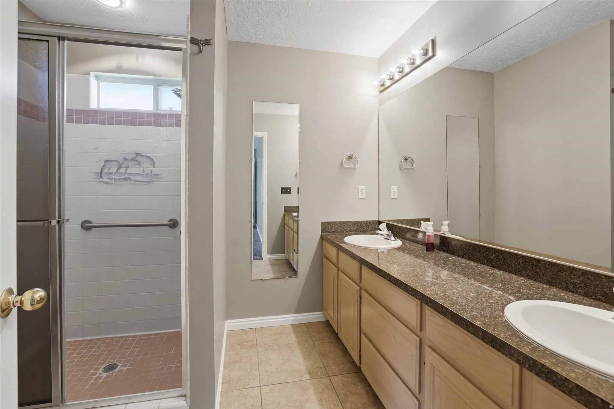 Primary bathroom  with double sinks and private shower