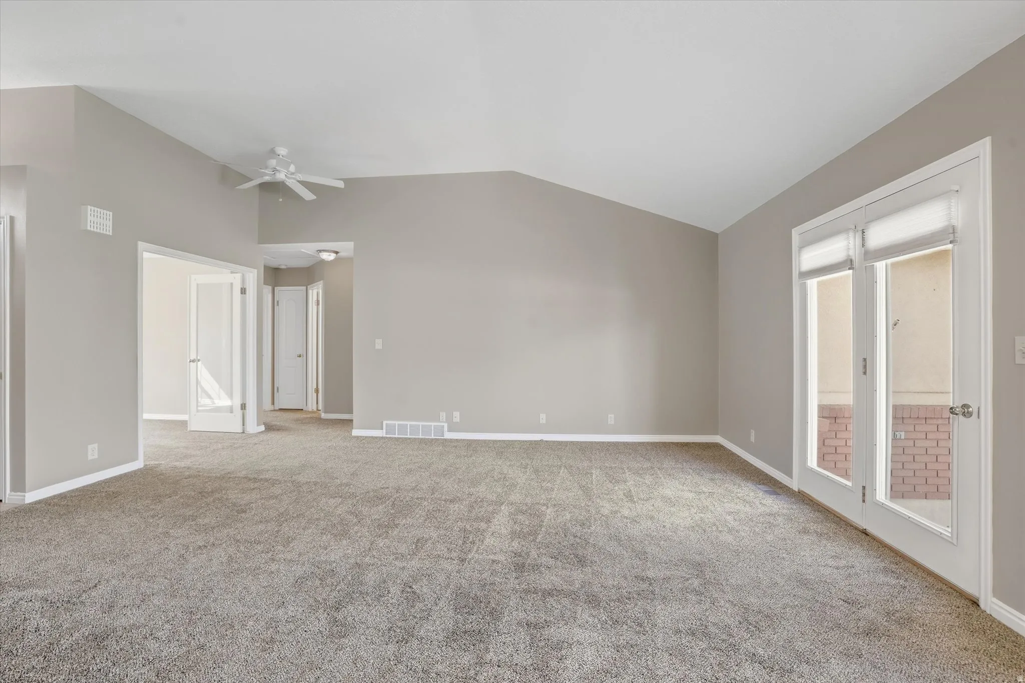 Open concept living room with lofted ceiling