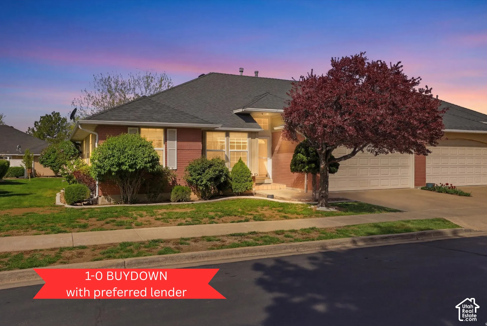 Single-story brick exterior featuring a multi-car garage, asphalt shingle roofing, and established landscaping