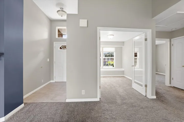 Front entry doorway and view of front office with French doors