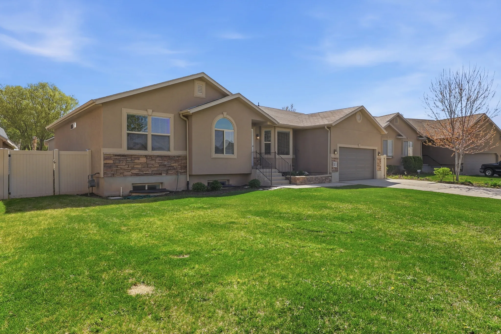 Ranch-style house with a gate to a large fenced back yard,