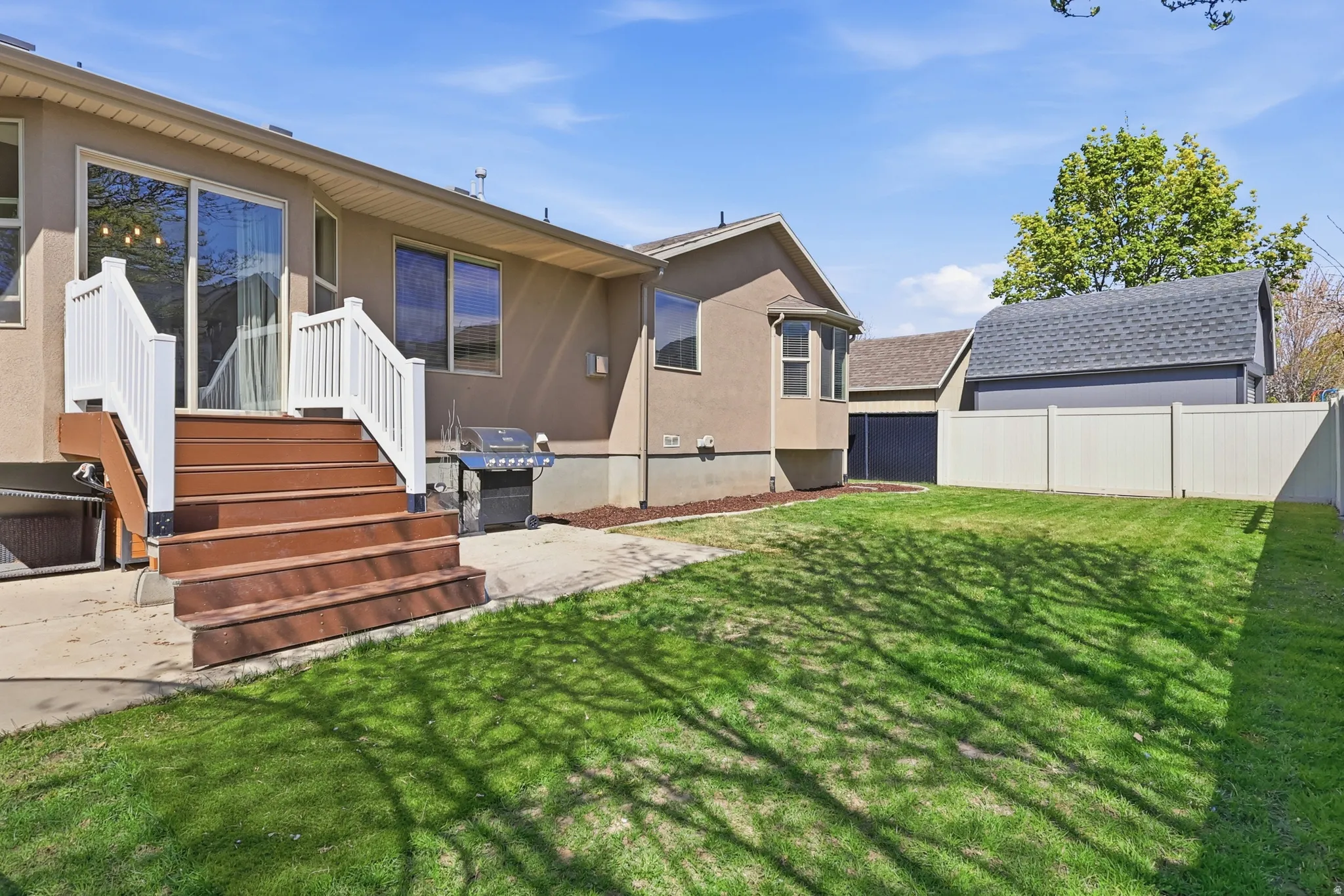 Back of property with stucco siding and a patio