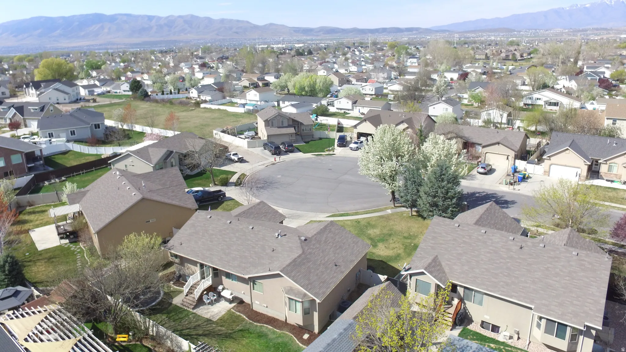 Aerial perspective of suburban area featuring an entrance to a park at the end of the cul-de-sac