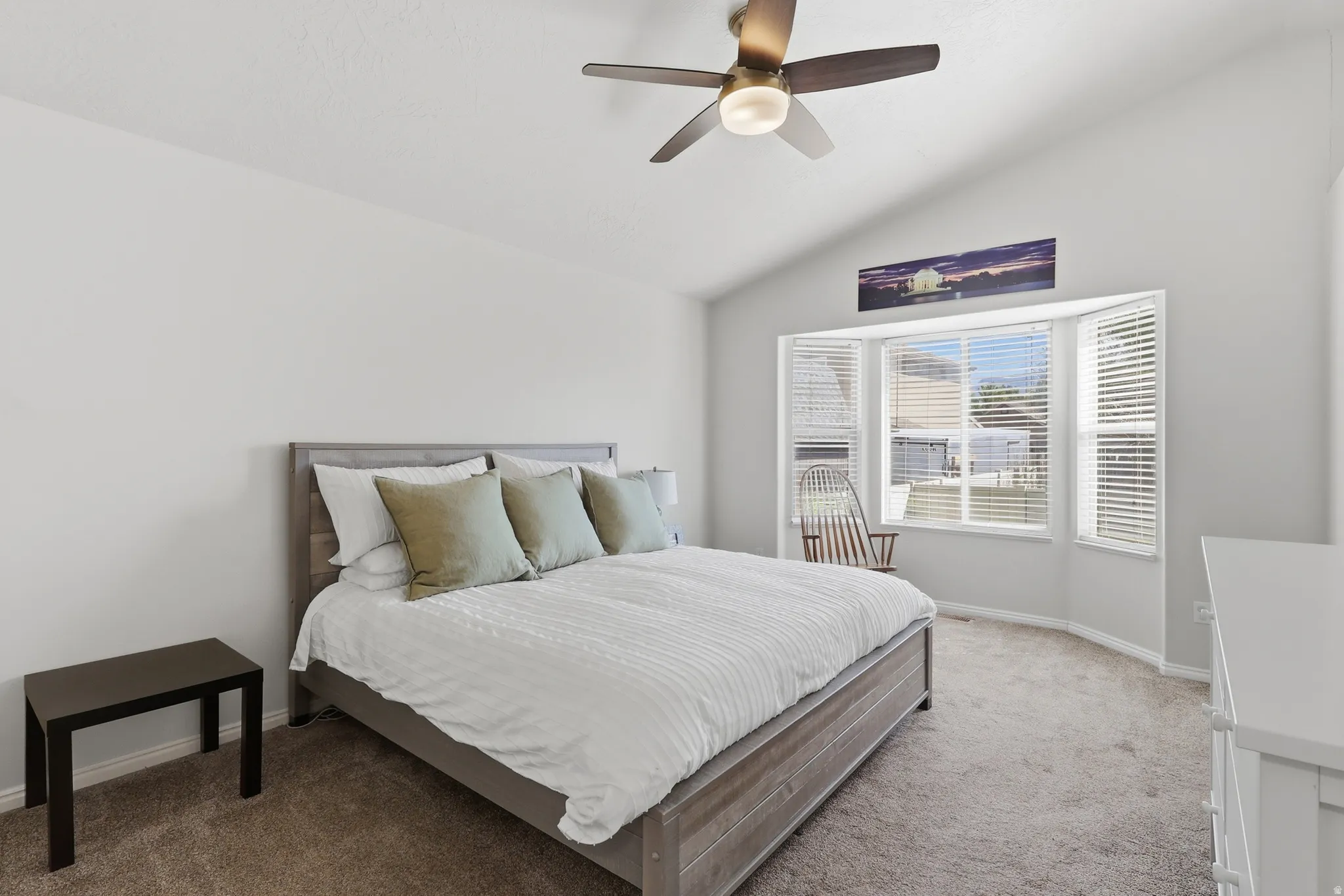 Large, light master suite with vaulted ceiling and large windows