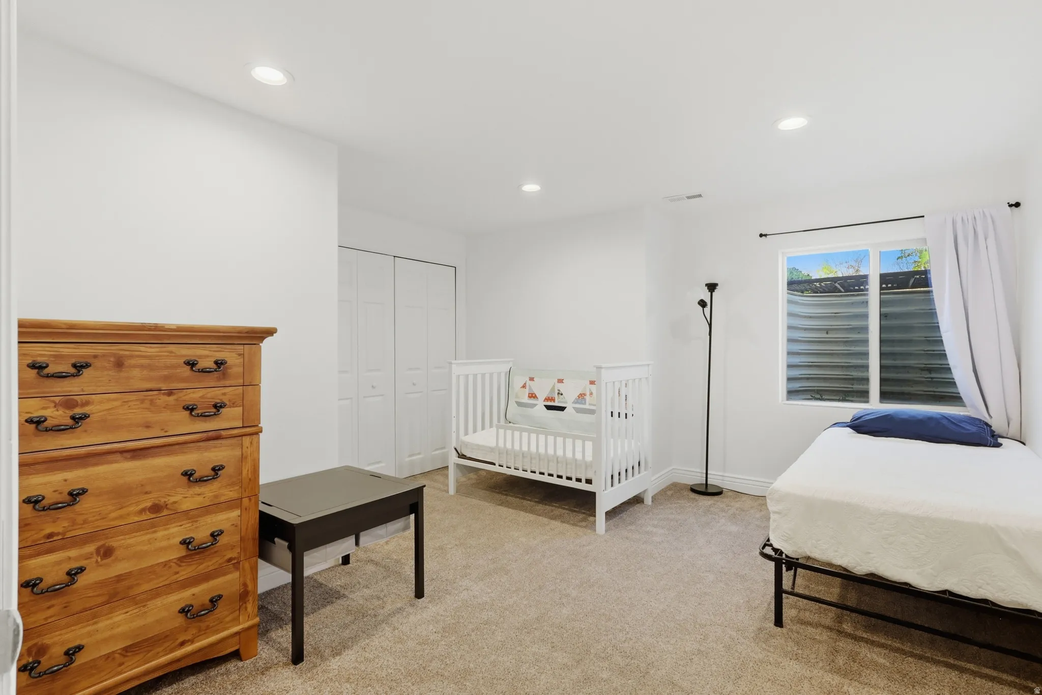 Bedroom #4 with recessed lighting, a large window, light carpet, and a closet