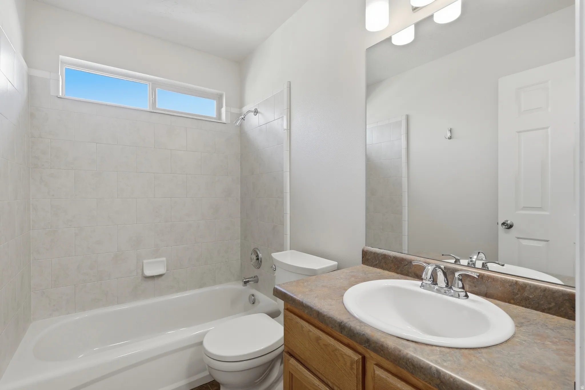 Full bath #2 on the main floor featuring vanity and shower/tub combination