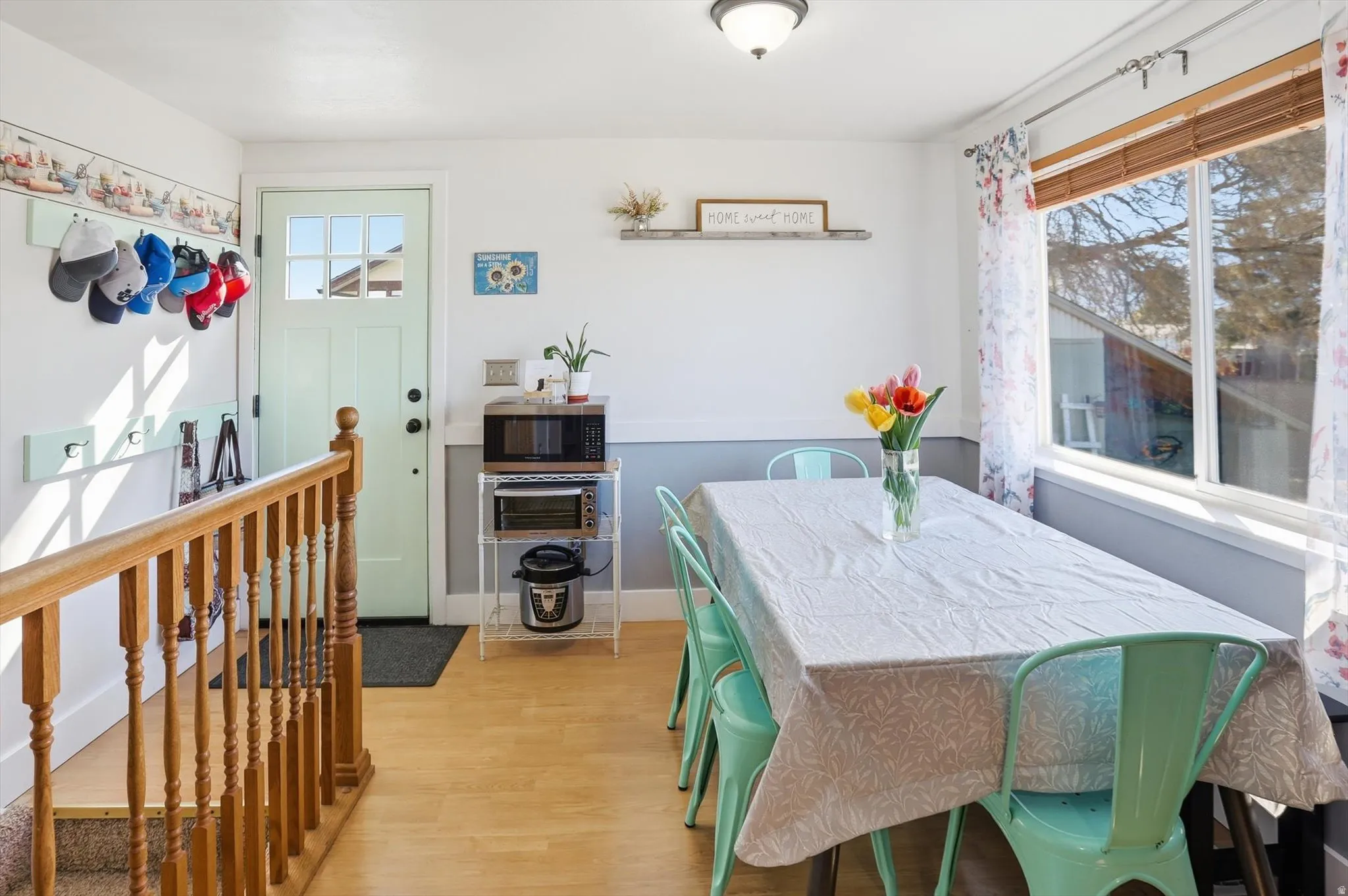 Dining room with light wood-type flooring and baseboards