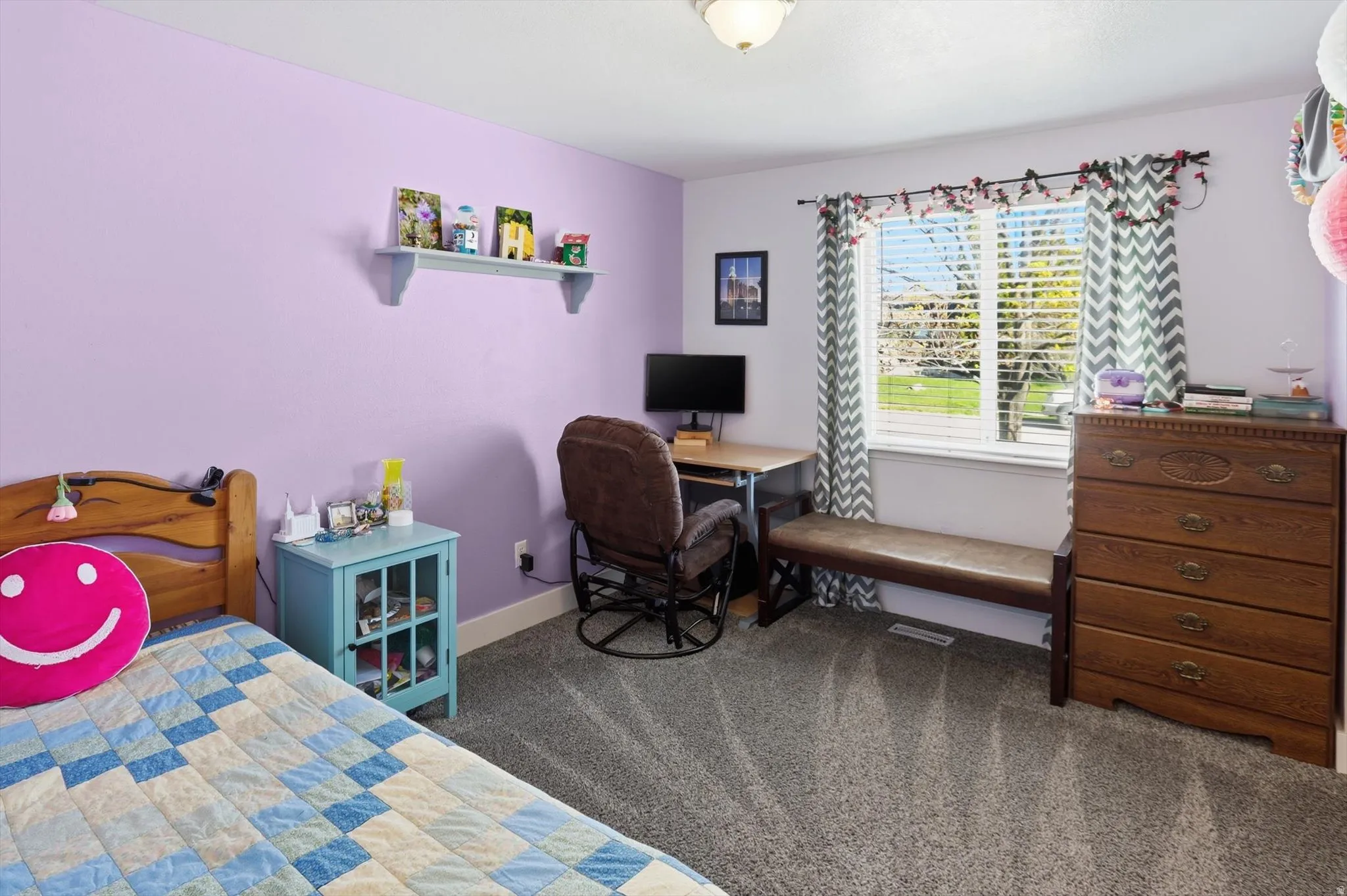 Bedroom featuring dark carpet and baseboards