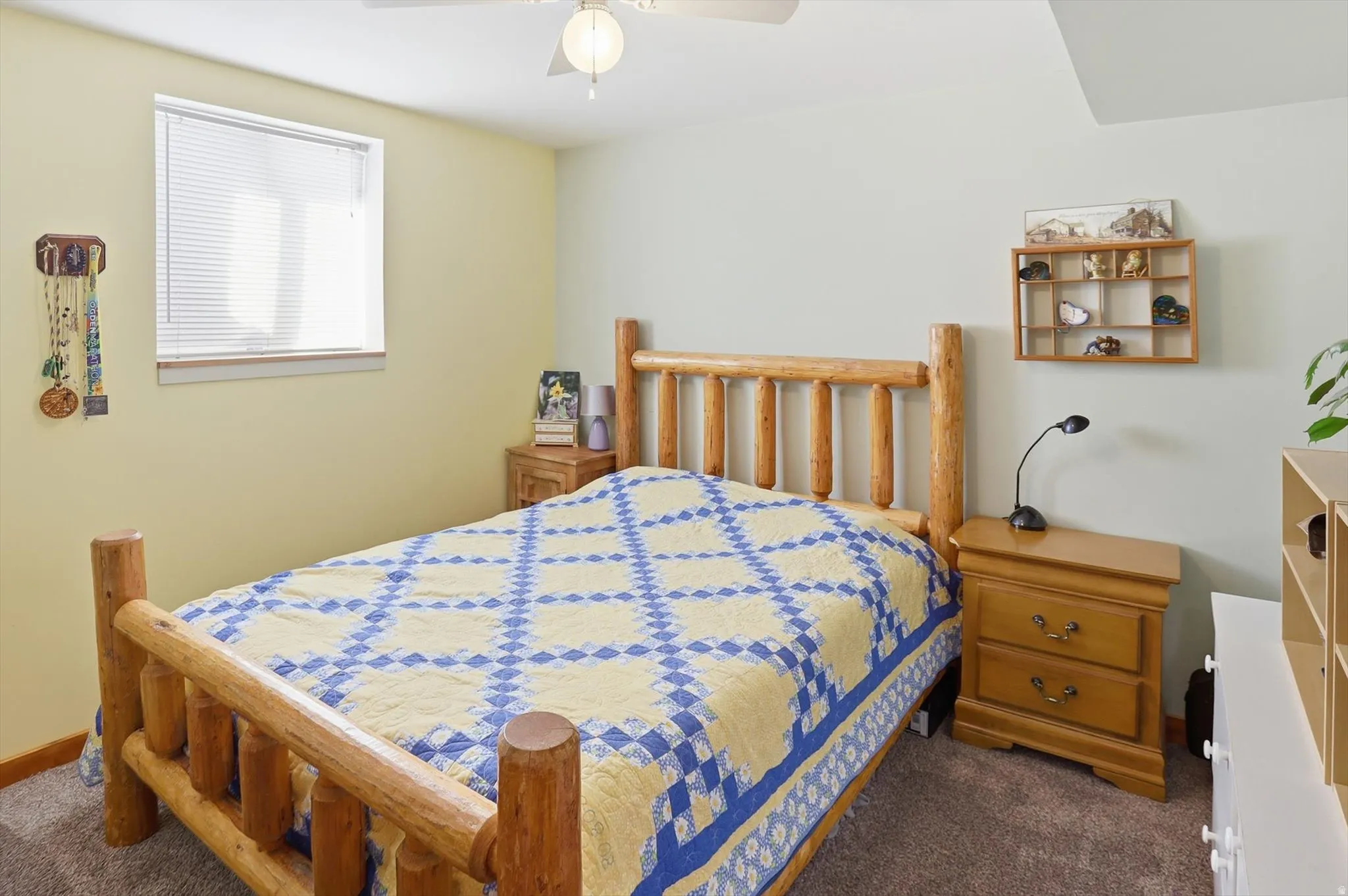 Bedroom with dark colored carpet and ceiling fan