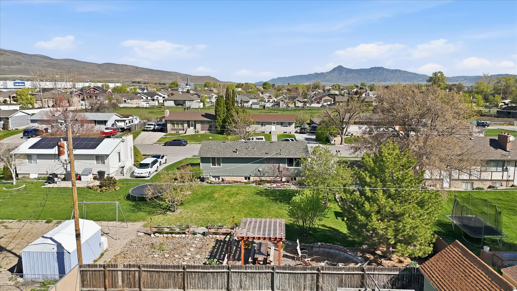 Aerial perspective of suburban area featuring a mountain backdrop