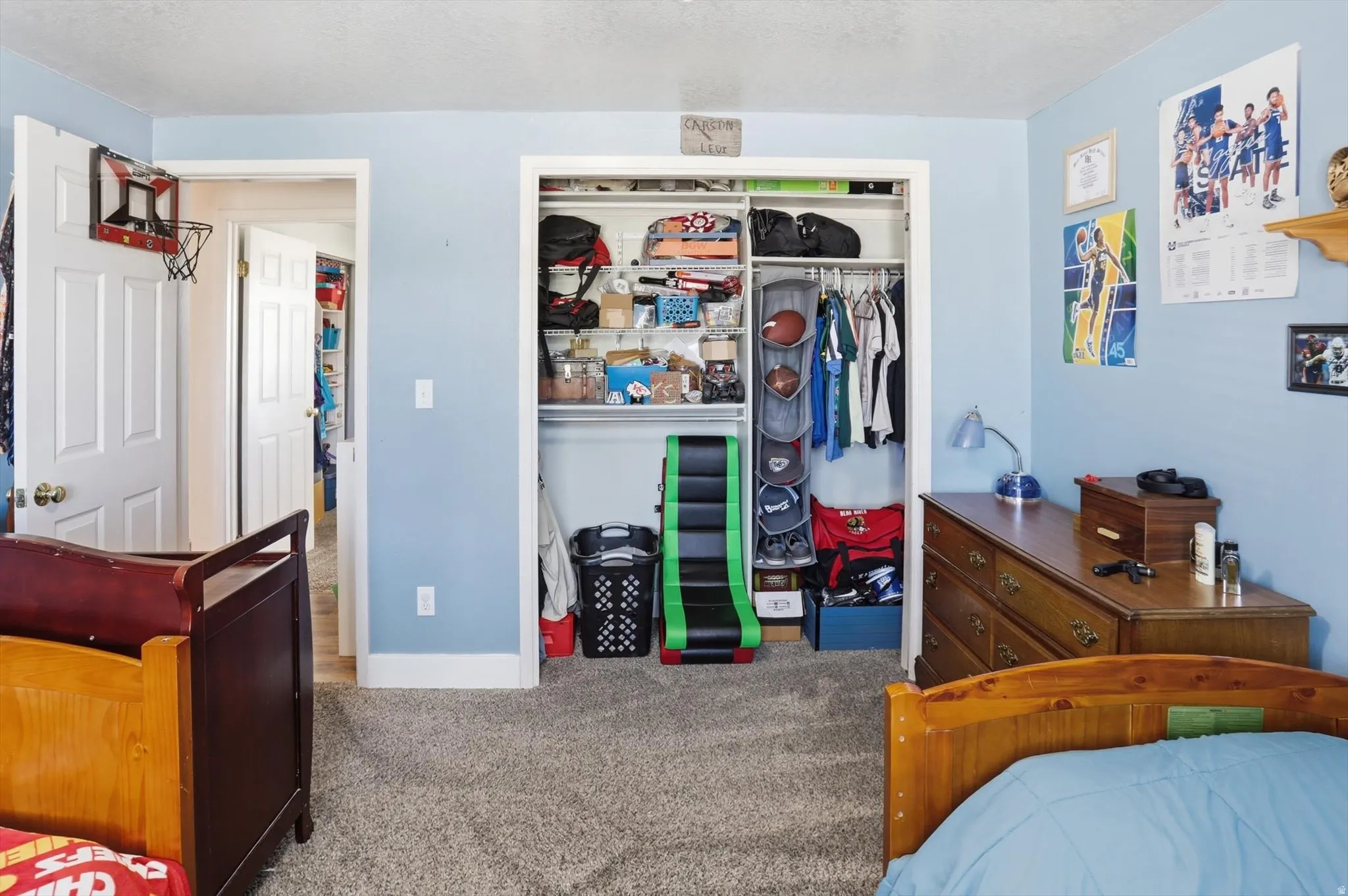 Carpeted bedroom featuring a closet and a textured ceiling