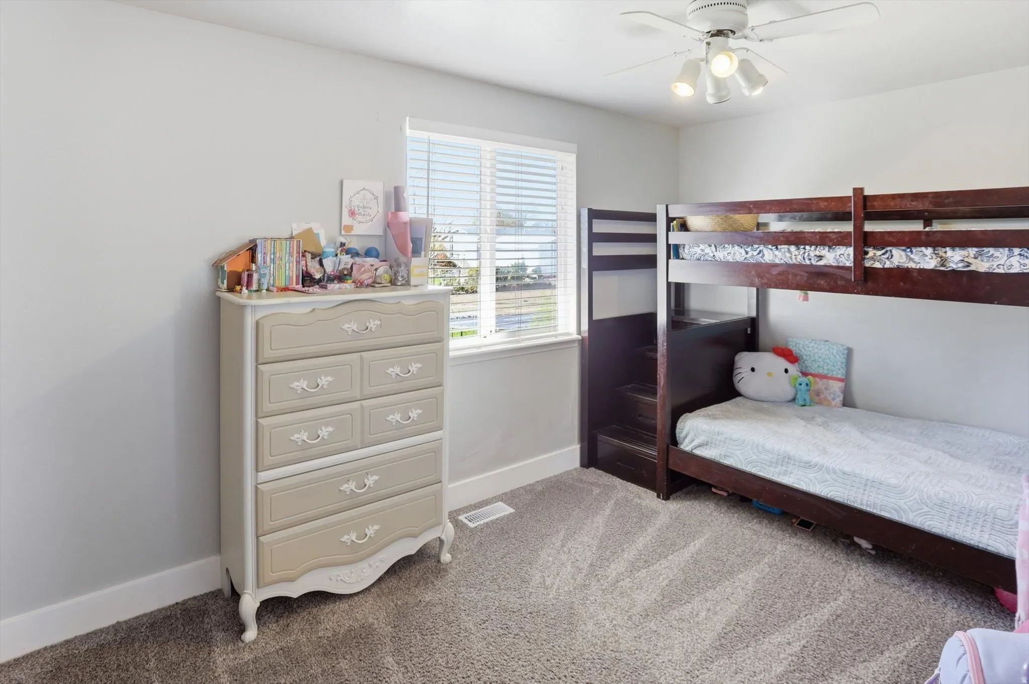 Bedroom featuring light colored carpet and a ceiling fan