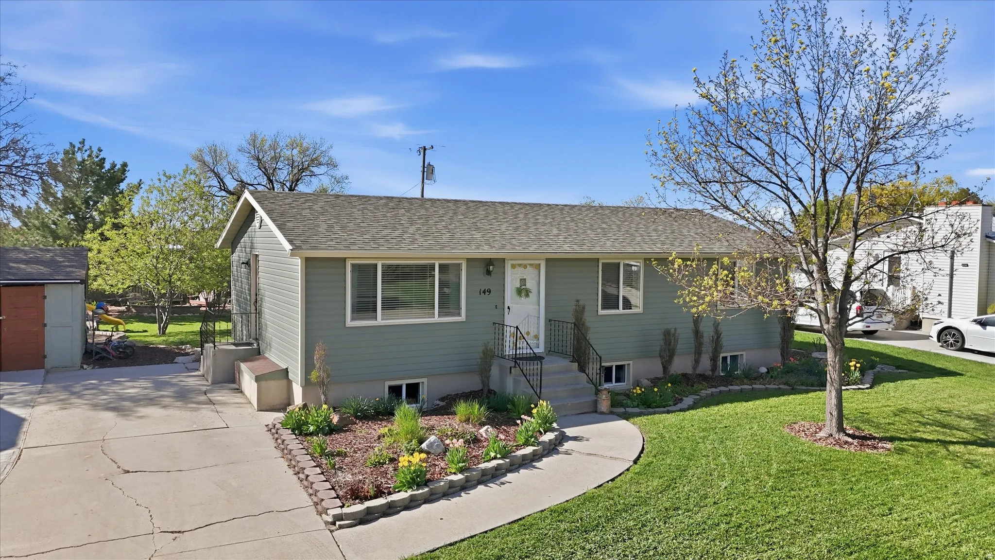 Single story home with roof with shingles and a front lawn