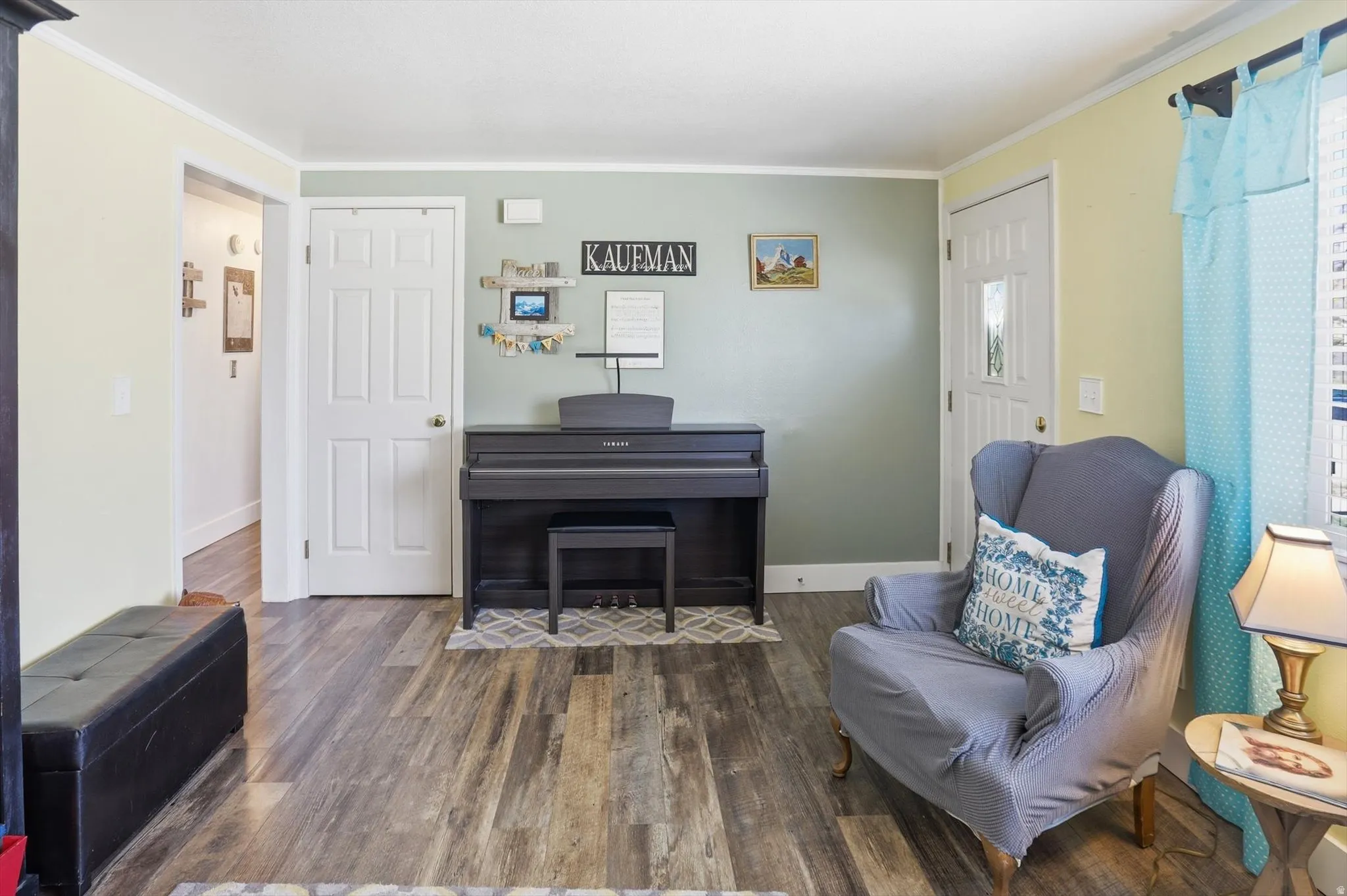 Sitting room featuring wood finished floors and ornamental molding
