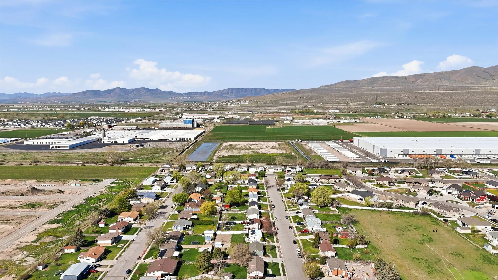 Aerial perspective of suburban area featuring a mountainous background