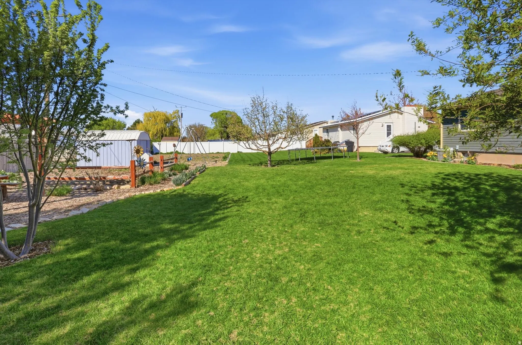 Fenced yard with an outbuilding