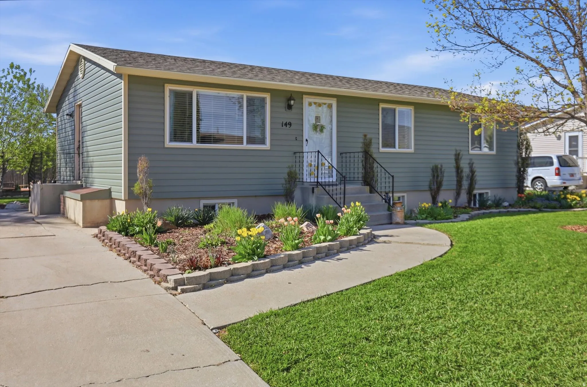 Single story home featuring a front lawn