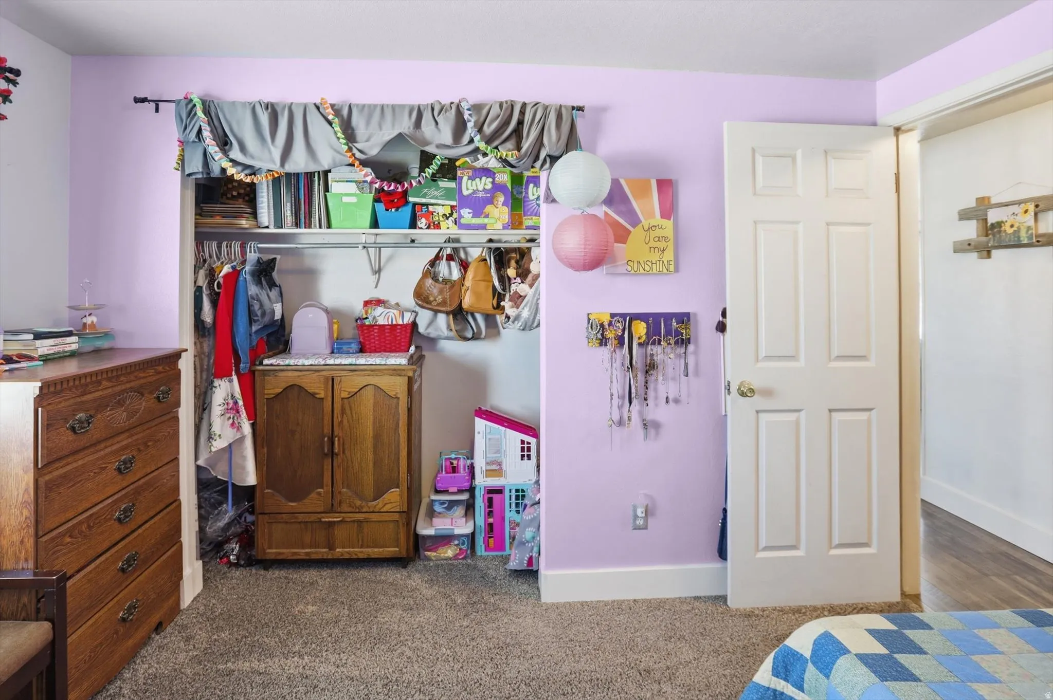 Bedroom featuring dark colored carpet and a closet