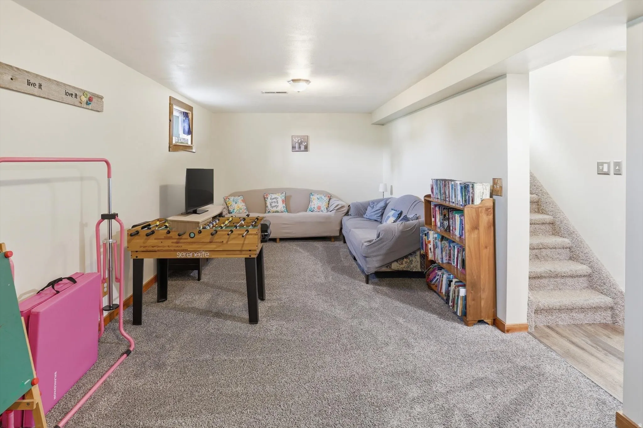 Playroom with light colored carpet and baseboards