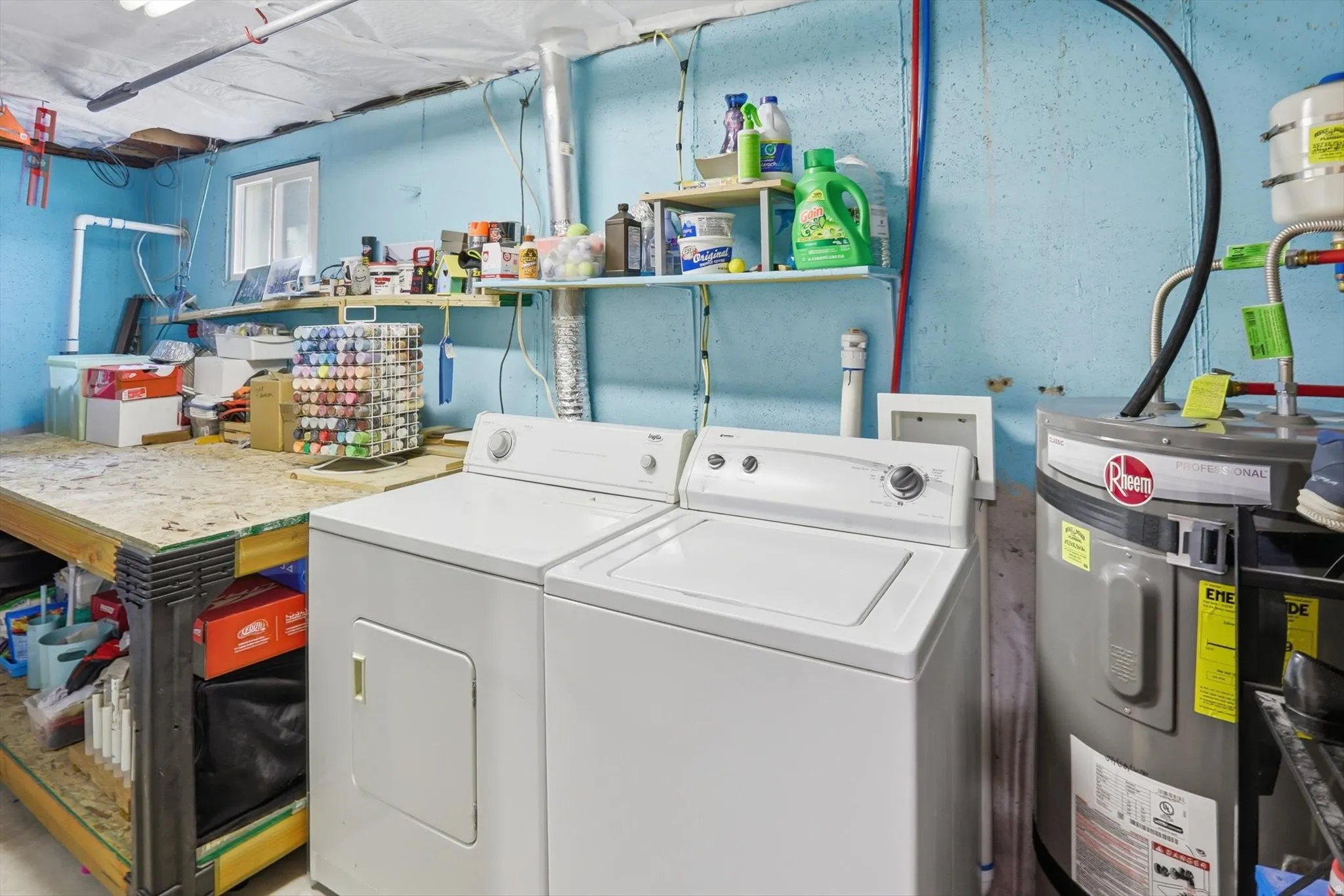 Laundry area featuring water heater and washer and clothes dryer