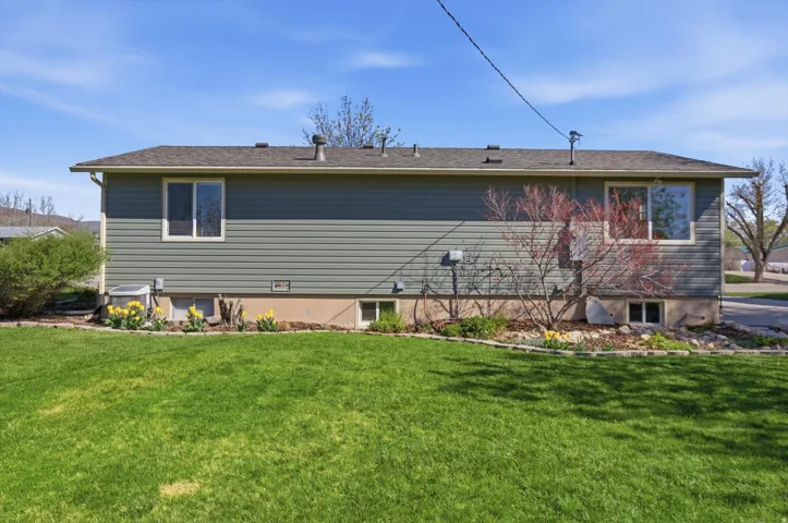 Rear view of house with a yard