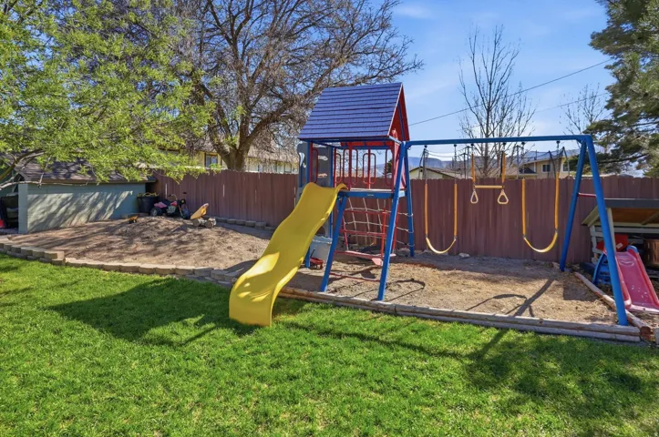 View of play area featuring a fenced backyard
