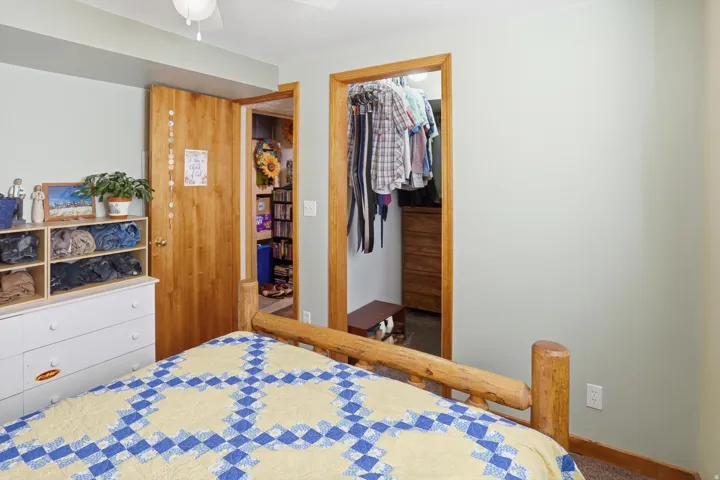 Bedroom featuring a walk in closet and ceiling fan