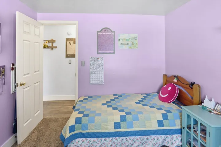 Bedroom with baseboards and carpet